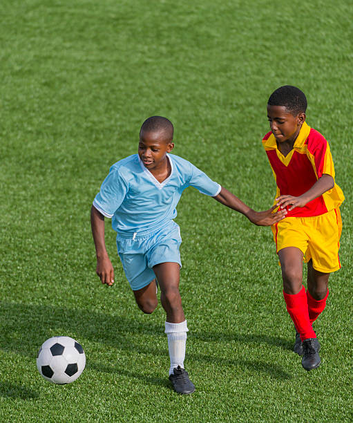 Two young players racing for the ball