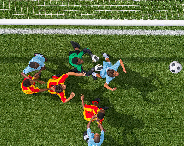 Players from both teams gathered at the goalmouth, seen from above